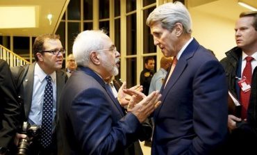 .S. Secretary of State John Kerry talks with Iranian Foreign Minister Javad Zarif after the IAEA verified that Iran has met all conditions under the nuclear deal, in Vienna