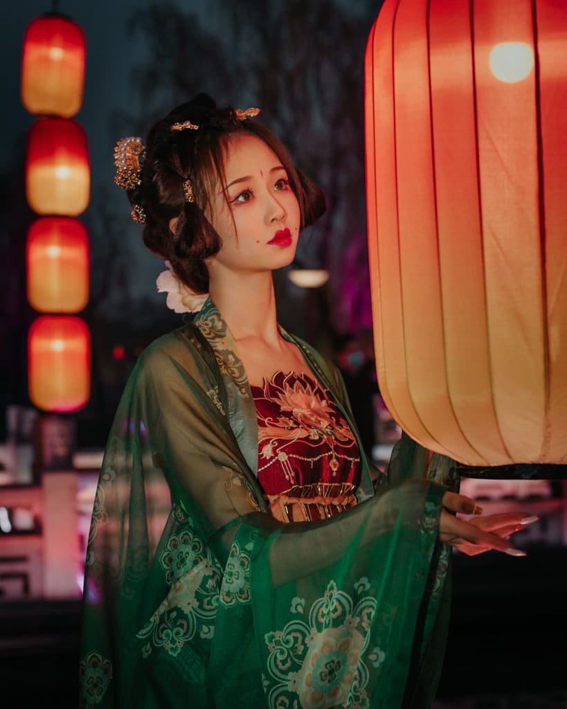 Chinese lady holding a fan, wearing red
