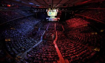 Massive esports MSG stadium, red and blue, aerial shot