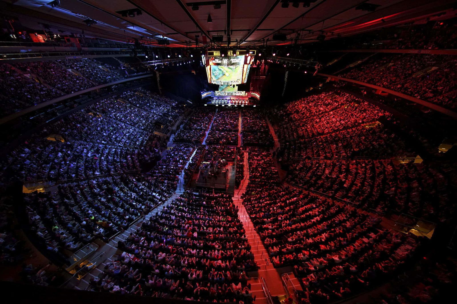 Massive esports MSG stadium, red and blue, aerial shot