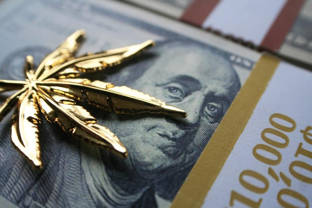 gold cannabis leaf on us dollar bill