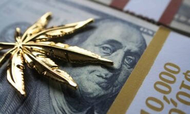 gold cannabis leaf on us dollar bill