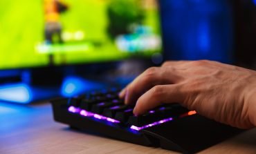 Cropped image of young gamer playing video games on computer